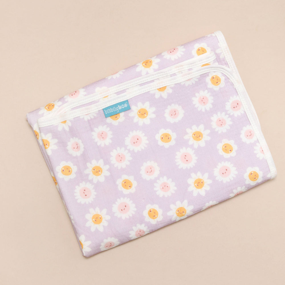 Floral-patterned changing mat on a beige background