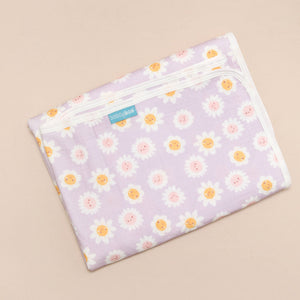 Floral-patterned changing mat on a beige background