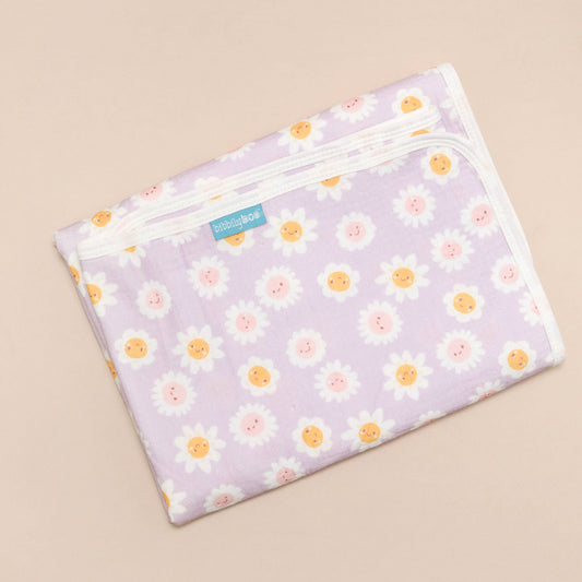 Floral-patterned changing mat on a beige background